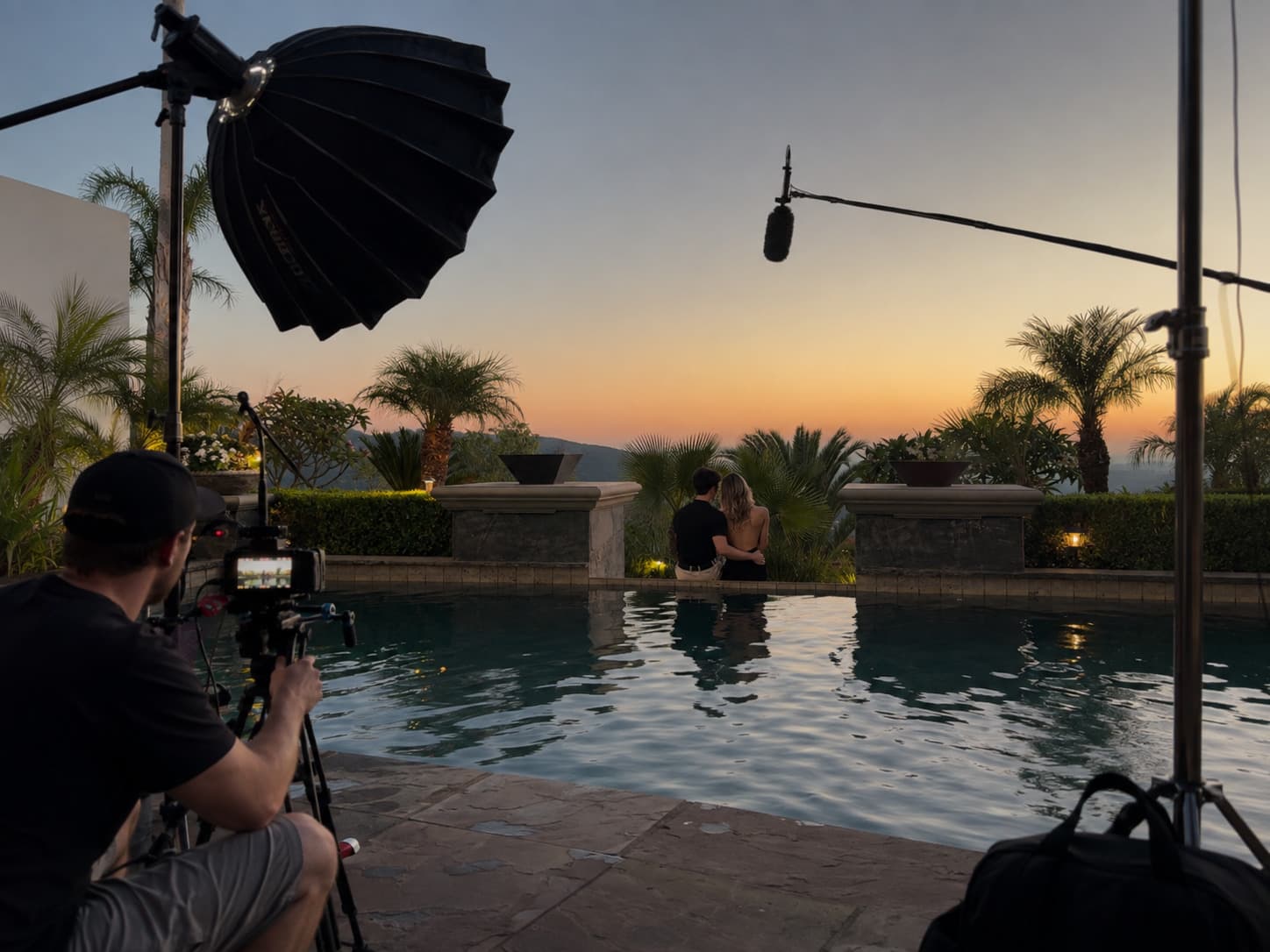 Shooting a poolside scene at golden hour, boom and key light rigged over the water